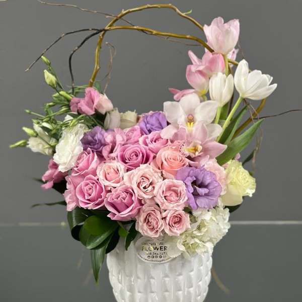 Pink and white floral arrangement in a white vase