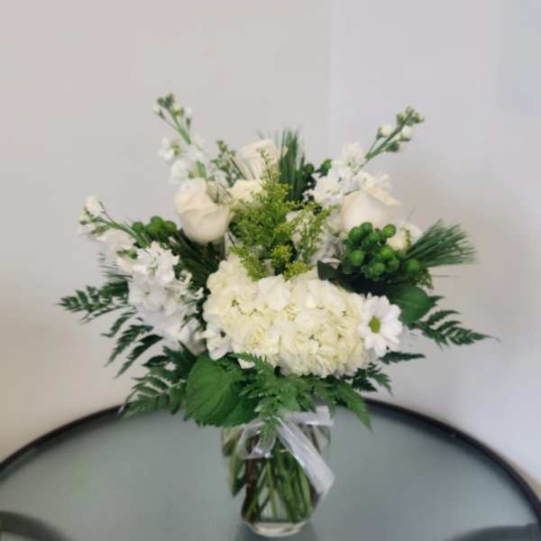 White floral arrangement in a clear glass vase