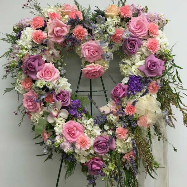 Heart-shaped floral wreath with pink and purple roses and white blooms