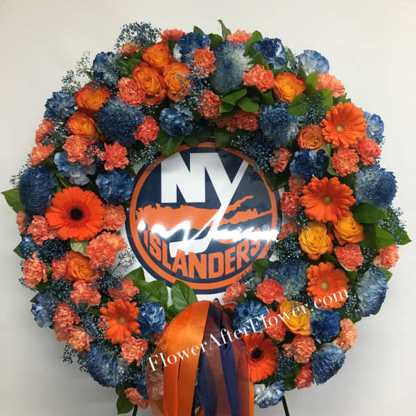Circular floral wreath with orange and blue flowers around a logo sign