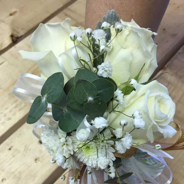 White rose wrist corsage with baby's breath and ribbon
