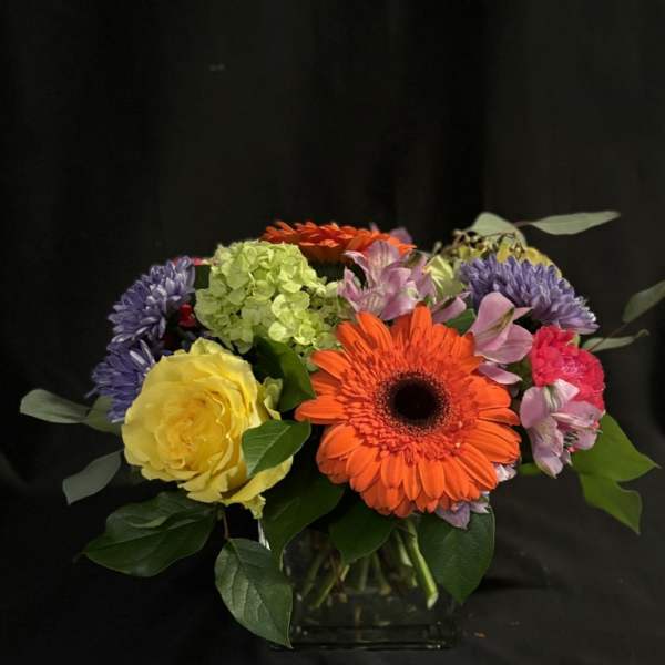 Colorful mixed bouquet in a clear glass vase