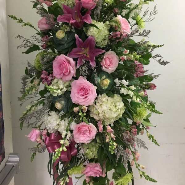 Tall pink and white floral standing arrangement with roses and lilies
