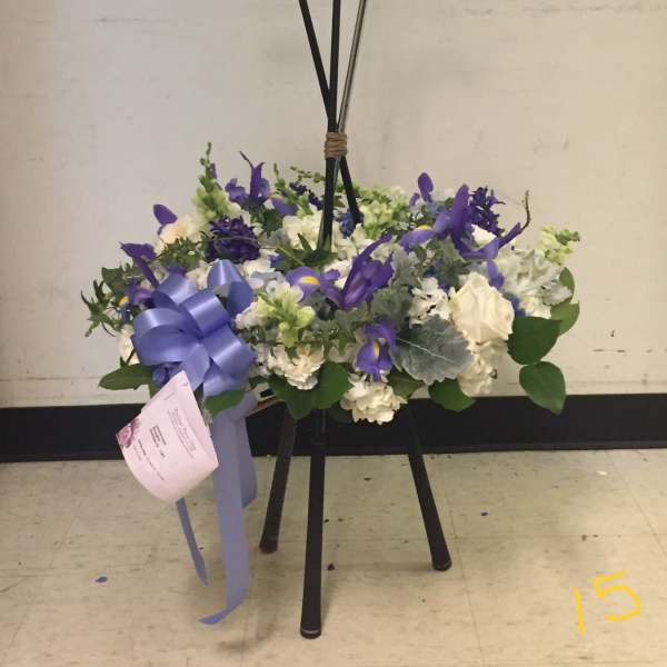 Floral arrangement on a golf-club stand with purple and white flowers