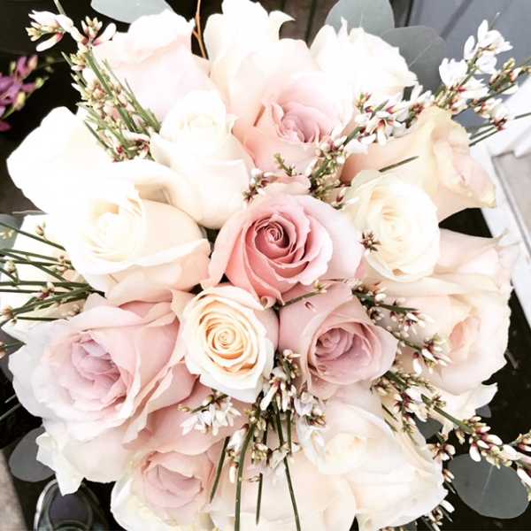 Bouquet of pale pink and white roses with small white filler flowers