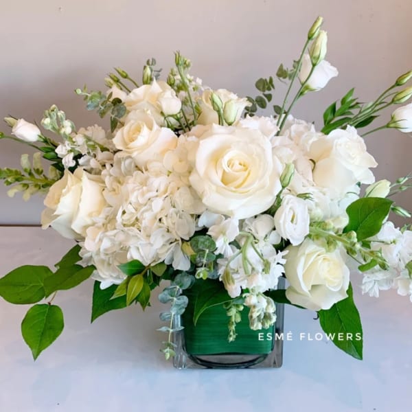 White rose and hydrangea arrangement in a glass vase