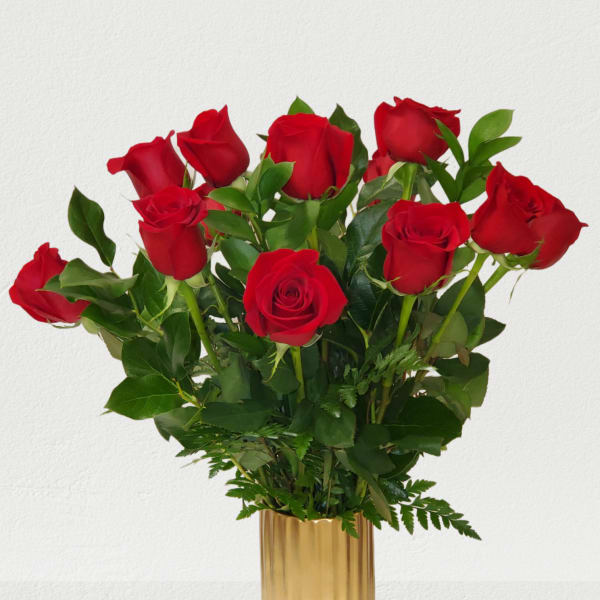 Red roses arranged in a gold vase