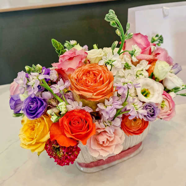 Colorful mixed flower arrangement in a clear glass vase