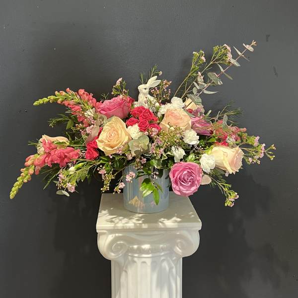 Mixed pink and cream rose arrangement in a glass vase