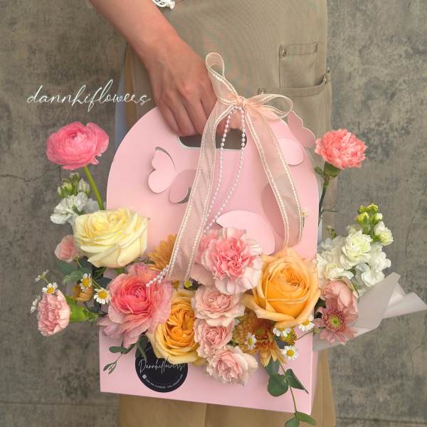 Pink gift box bouquet with roses, carnations, and daisies