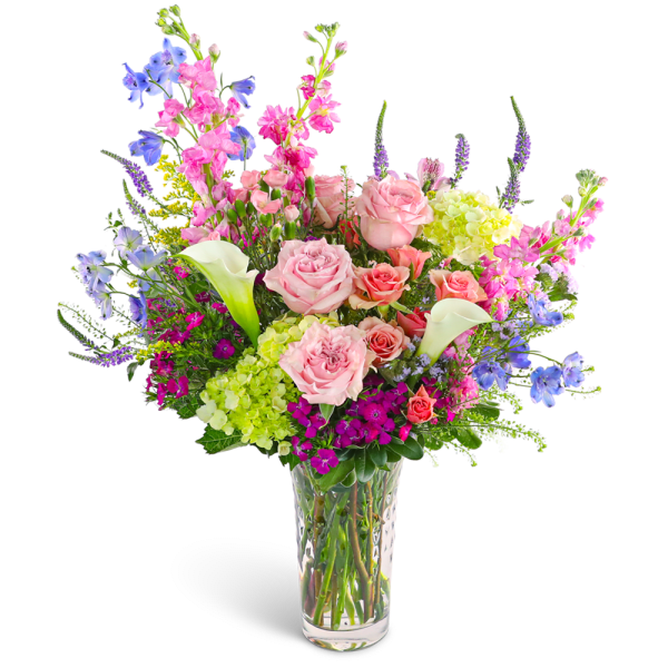 Mixed bouquet of pink roses, calla lilies, and blue flowers in a clear vase