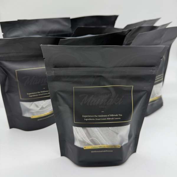 Three black resealable tea pouches on a white background