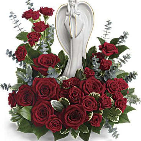 Red rose arrangement with an angel statue centerpiece