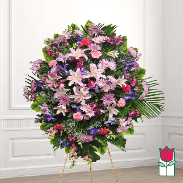 Large standing floral spray with pink, purple, and white flowers on a tripod easel