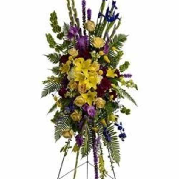 Tall standing floral spray with yellow and purple flowers