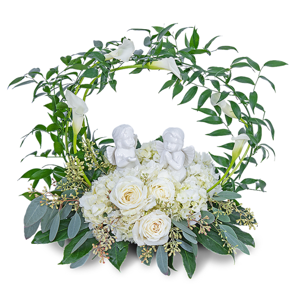 White roses and calla lilies in a circular floral wreath with angel figurines