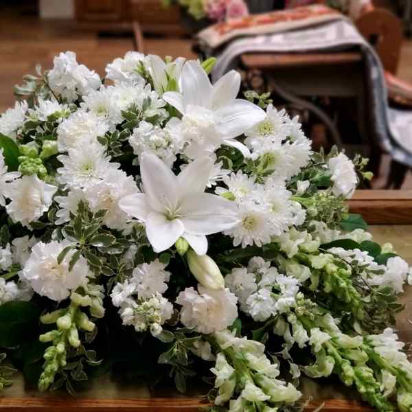 White floral arrangement with lilies and small white blooms