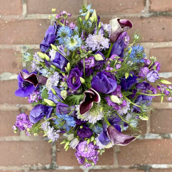 Purple bouquet with calla lilies and mixed blooms