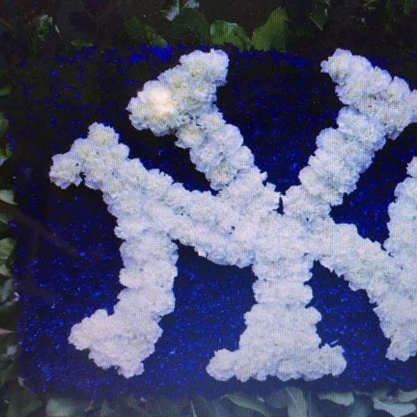 White floral letters on a deep blue flower background