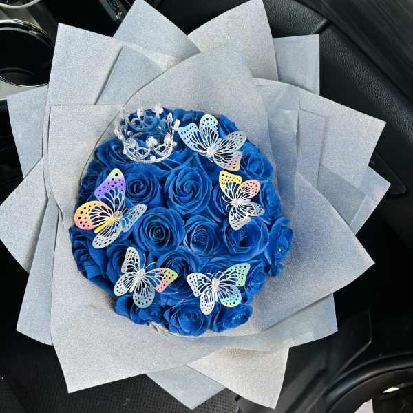 Blue rose bouquet with butterfly decorations and silver wrap