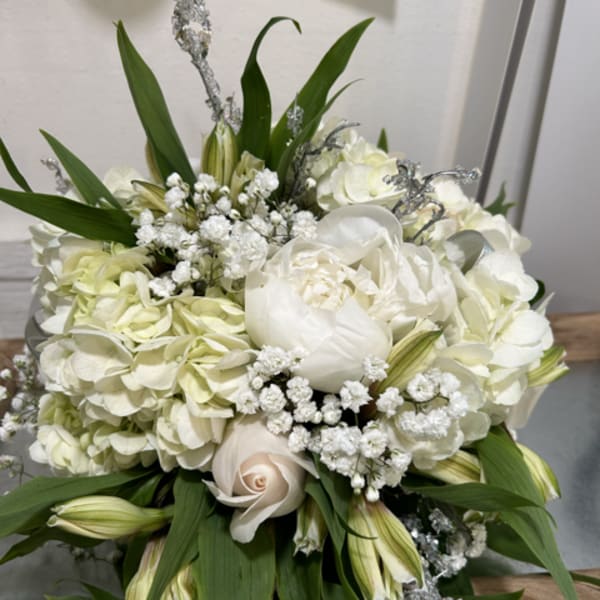 White floral bouquet with hydrangeas, lilies, and roses
