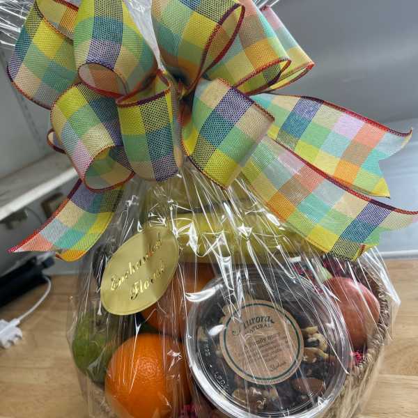 Gift basket with fruit and a large plaid ribbon