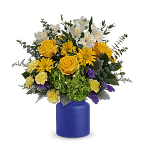 Yellow and white mixed bouquet in a blue vase
