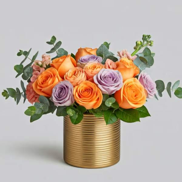 Orange and lavender roses in a gold ribbed vase