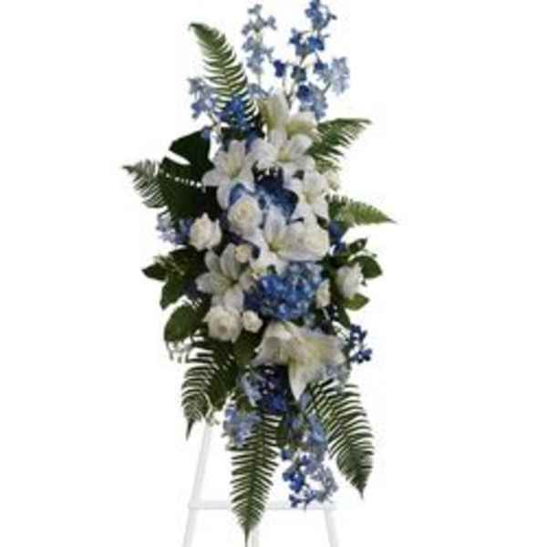 Tall blue and white floral standing spray on an easel