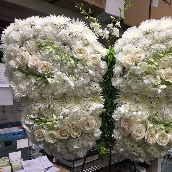 Large white floral butterfly display with roses and chrysanthemums
