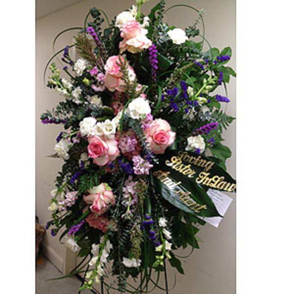 Tall standing floral spray with pink and white roses and purple accents