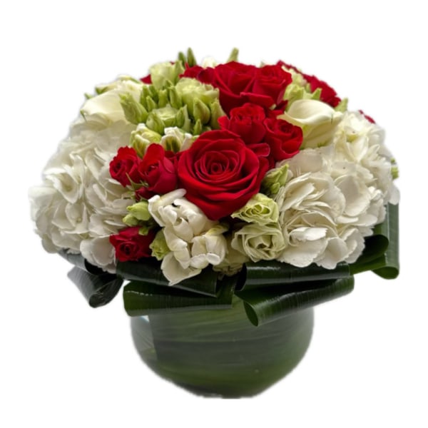 Red and white rose bouquet in a green vase