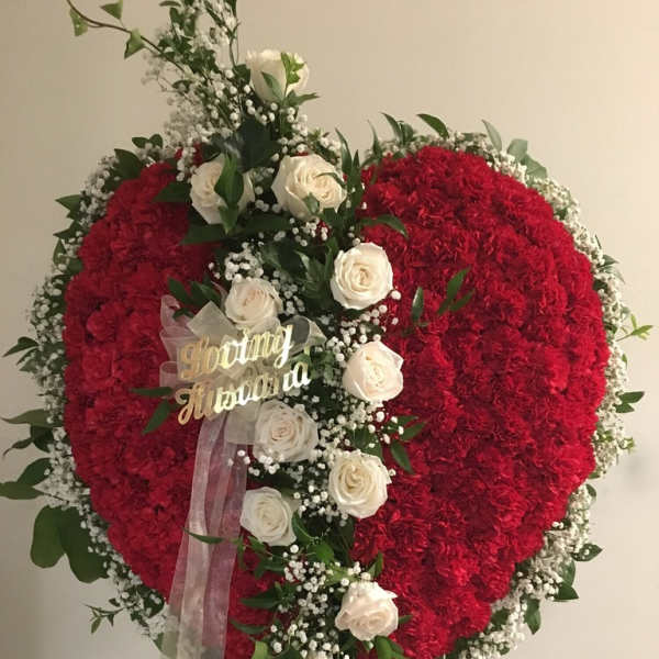 Heart-shaped red floral standing spray with white roses and ribbon