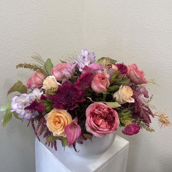 Pink and lavender mixed bouquet in a white vase