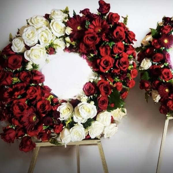 Two large floral wreaths of red and white roses on stands