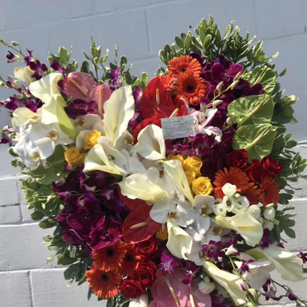 Heart-shaped floral standing arrangement with white calla lilies and orchids