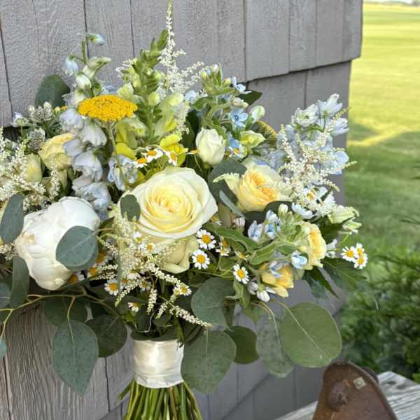 Bouquet of white and pale yellow flowers with eucalyptus