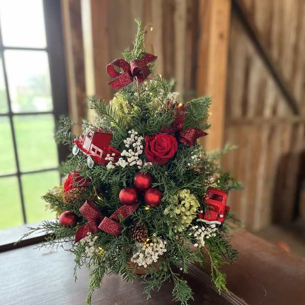 Small Christmas tree arrangement with red roses and ornaments