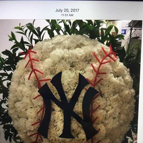 White floral wreath with a black Yankees logo and red stitching accents