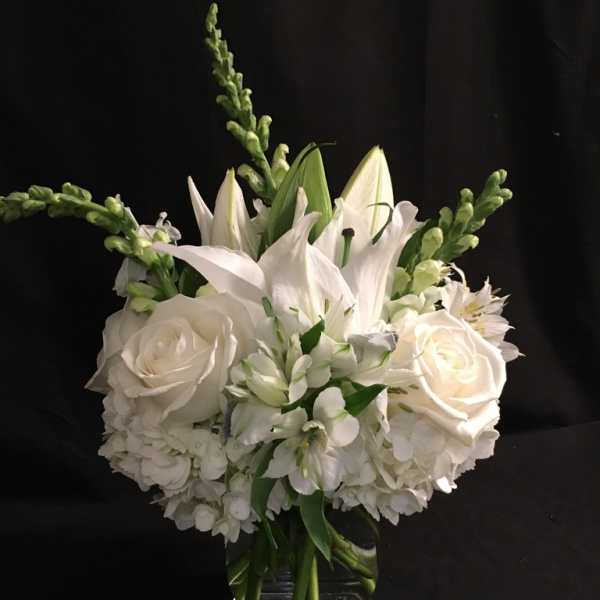 White floral bouquet in a clear glass vase
