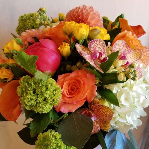 Bright mixed bouquet with orange, pink, yellow, and white flowers
