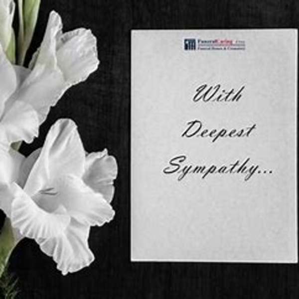 White gladiolus flowers beside a sympathy card