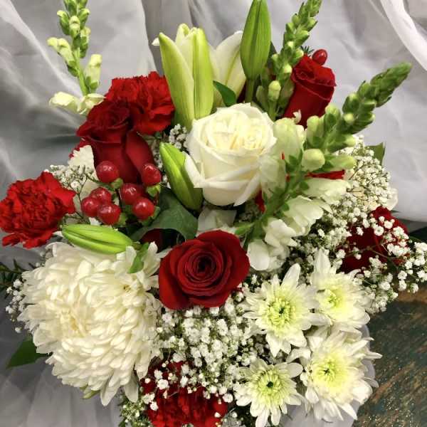 Bouquet of red and white flowers with lilies and roses