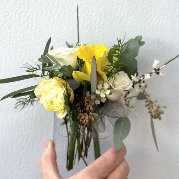 Small bouquet with yellow and white roses and greenery