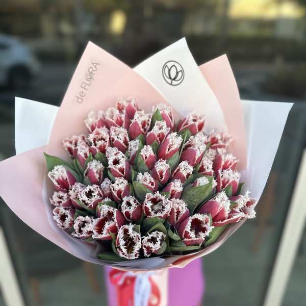 Bouquet of pink fringed tulips wrapped in pastel paper