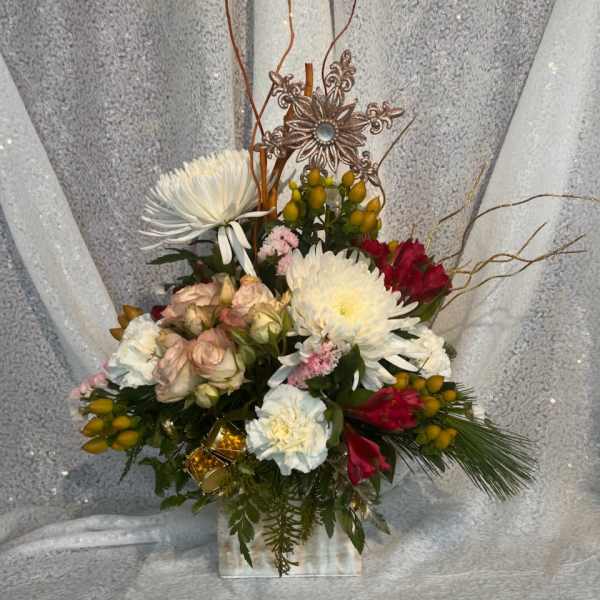Mixed bouquet in a clear vase with white, pink, and red flowers
