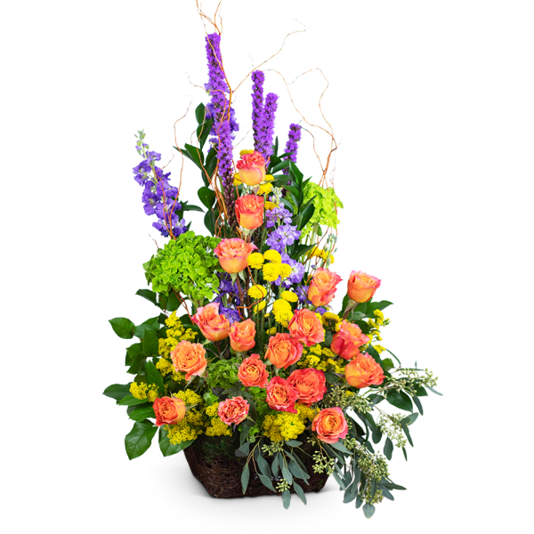 Tall arrangement of orange roses, purple spikes, and yellow flowers in a basket