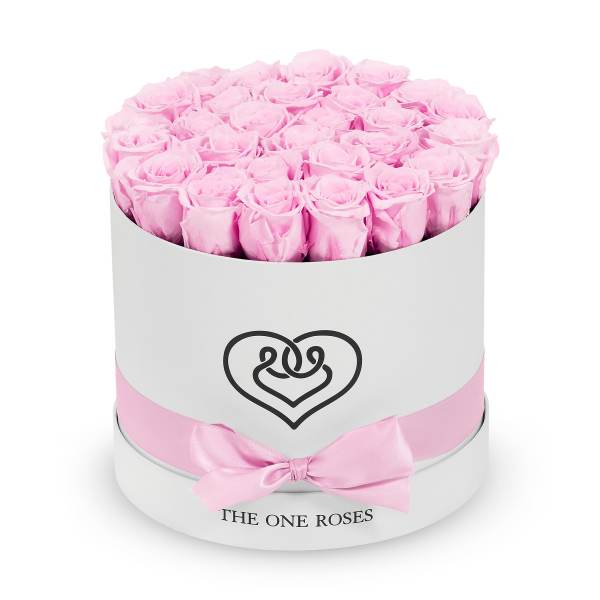 Pink roses arranged in a round white hat box with a pink ribbon