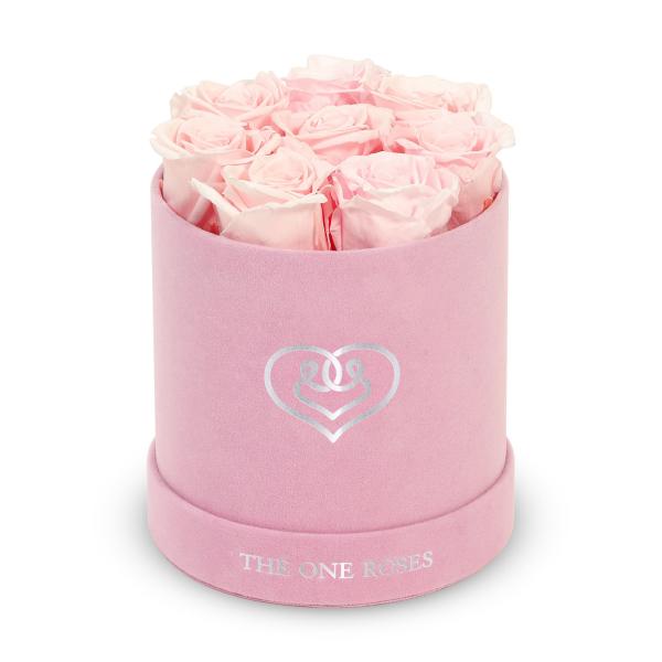 Pink roses arranged in a round pink hat box