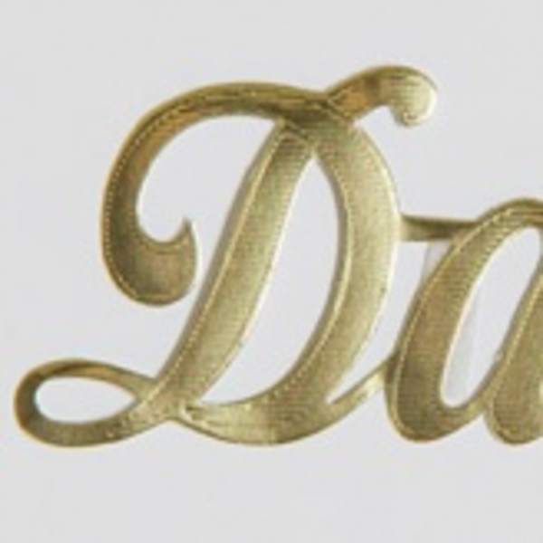 Gold script word "Dad" on a white background